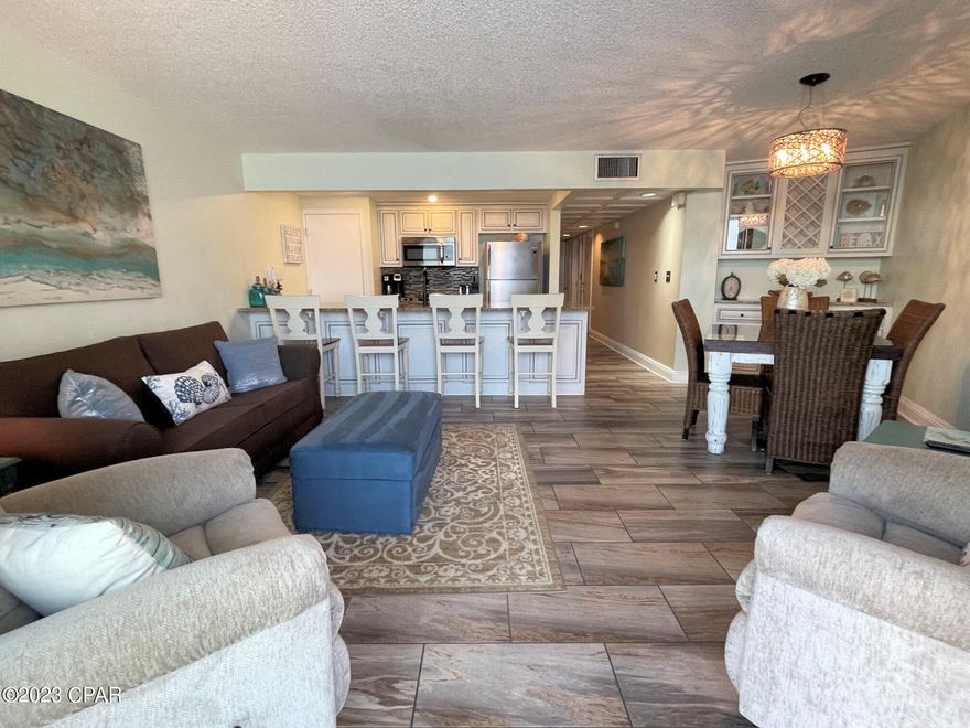 Looking for a Turn-Key beach getaway? This is a beautiful remodel on a Gulf-Front condo at Edgewater Beach Resort. There is a lot of custom work, handmade cabinets with wine rack, tile wood-look flooring, and quality furnishings. Check out the brand new dual open balcony sliding doors!!  Gorgeous! AC installed 2021 and well maintained. A spacious coastal oasis with floor-to-ceiling windows to bring in natural light and a private balcony full of salty breezes. You will find the resort-style view to the beach is magical day or night! Tower II has its own heated pool with waterfall. Indulge in the coastal lifestyle and explore exclusive amenities such as tropical heated pools, cabanas, hot tubs, golf, tennis, pickleball, gym, salon services, restaurant and bar. Stunning beaches and soul touching sunsets are yours to discover. Many fun activities planned just for the kids. Walkable to dining, shops, entertainment, convenient to Pier Park. Pet friendly for owners. Lots of building-side parking including electric, RV, boat and trailer. Gated and secure. Ask for a Cost To Own Estimate with rental income.