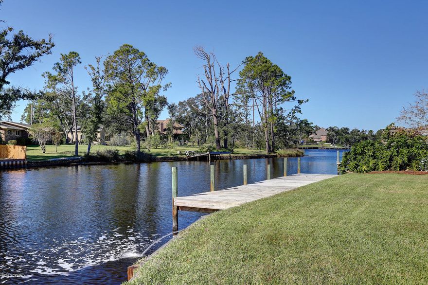 Don't miss this opportunity for a great home on good boatable water, there aren't many out there!  On a natural body of water with good depth that has quick access to the bay and a short ride to the pass.  This 4 bedroom 3.5 home offers great space and layout in a beautiful setting.  The waterfront master is located on the first floor with two separate vanities, a soaking tub and separate shower, all recently renovated.  There is one additional bedroom and full bath on the first floor or use it as an office.  The two upstairs bedrooms are large with each an oversized walk-in closet and walk in attic space for all your Christmas decorations and more!  These bedrooms share a sizeable full bath.  The kitchen window overlooks the back en kitchen island, desk, and breakfast area.  The laundry/pantry/garage/dining and family room are all conveniently accessible.  The family room is large with views of the water, a fireplace and guest bath that is accessible from the garage.  Great for when working outside and don't want to trek through the house.  The attractive workshop is well designed with lighting and power and windows which make it a great workspace for projects or crafts. The home has a dock and a covered boatlift.  Jump on your boat after work for relaxation or a quick catch for dinner.  This would be a good place for paddle boarding and kayaks for all.  There is a double garage and circular driveway, enough parking for everyone.  The street is a circle off the beaten path yet convenient to area shopping, medical, and restaurants.   Call today, you may not get another chance at this one.