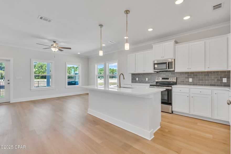 NO RENTAL RESTRICTIONS!!! Our stunning pool is NOW OPEN! The prefect place to SOAK UP THAT Florida SUN! Seagate at Clara is a new townhome community nestled in the vibrant city of Panama City Beach, FL. This two-story unit features board and batten exterior and covered entries. One car garage provides a great space for storing beach essentials. This Unit has a LARGE FENCED IN PRIVATE YARD.  This open concept townhome boasts a stylish kitchen with white cabinets, tile backsplash, a large island with quartz counter tops - perfect for entertaining.  The elegant Owners Suite is designed with comfort in mind showcasing a large walk in closet and double- bowl vanities. Main Bath has tiled shower.  All bathrooms have quartz countertops.  LVP is located throughout the home.  The community pool features a cabana, lounging, seating and grilling stations. This community has a dedicated dog park. Seagate at Clara is in a prime location, approximately 1.4 miles to the sandy beaches and just minutes from Pier Park.