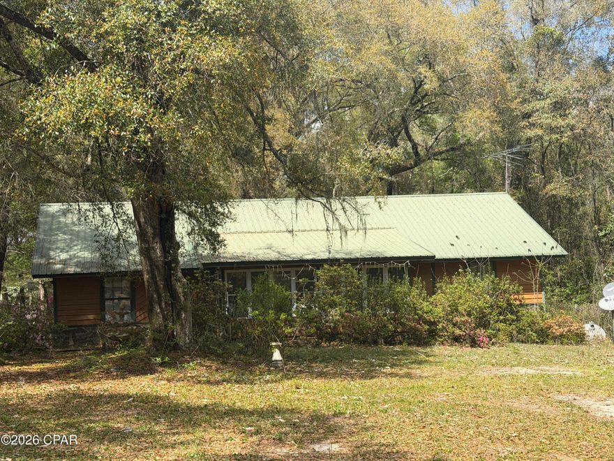 Welcome to your dream homestead! This 3-bedroom, 2-bath home is the fixer upper you've been looking for. Sitting on 2.8 acres full of opportunity for someone ready to restore its charm and bring it back to life. With great bones and endless potential, this property is just waiting for your vision and personal touch.
In addition to the main home, the property features an old church building that offers incredible versatility, perfect for renovation into a workshop, studio, guest space, or an impressive garage for mechanics, hobbyists, or anyone needing substantial storage.
Equestrian and farm enthusiasts will love the horse barn and fenced acreage, ideal for horses, livestock. 
Located just 5 minutes from Holmes Creek and less than 30 minutes from Panama City Beach, this property offers the perfect blend of peaceful country living with convenient access to nearby amenities.
Endless possibilities await, schedule your showing today and bring your vision to life.
Recent appraisal valued property as is at $175k.

HOME IS A FIXER UPPER AND IS NOT CURRENTLY LIVABLE. PROPERTY WILL NEED RENOVATION PRIOR TO OCCUPANCY. CASH ONLY.
ALL MEASUREMENTS ARE APPROXIMATE AND SHOULD BE VERIFIED.