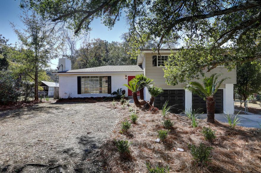 LARGE HOUSE WITH IN-GROUND POOL - OVER 1/2 ACRE NEAR TYNDALL AFB! The interior of this beautiful home features 4 bedrooms, 2.5 Baths, an open floor plan perfect for entertaining, a wood-burning fireplace, new tile flooring throughout (no carpet), ample natural light, a brand new kitchen, new bathroom features, an interior laundry room and a 2 car garage. The kitchen boasts great counter and cabinet space, granite counter tops, a huge island with breakfast bar, open wood shelving, stainless steel appliances and a pantry.  The kitchen and dining area overlook the XL in-ground pool.  The 17x13 Master bedroom has a balcony overlooking the pool and backyard. The additional 3 bedrooms are good size. The exterior features an XL chain-link fenced backyard, a double gate for backyard vehicle access, an in-ground pool with pool deck, a large concrete slab for recreation or parking and new landscaping. This home is stylish and great for entertaining.  Located right next to a park.  Call today for a private preview. All information derived from public record and seller; buyer to verify. Measurements approximate.