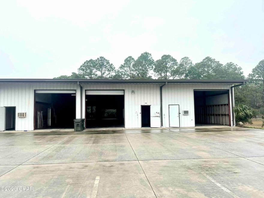 LARGE INDUSTRIAL WAREHOUSE AVAILABLE FOR LEASE, END UNIT, PREVIOUSLY AN AUTOMOTIVE MECHANIC BUSINESS- 7,500sf of industrial warehouse with (3) 500sf office/restroom spaces and 6,000sf of flex warehouse space  (3) restrooms, (6) 12'x12' roll up doors (3 in the front and 3 in the back for air flow. 24 hour exterior security cameras. Riviera Commerce Park is centrally located between the Hathaway Bridge and Highway 79 on Hutchison Blvd. in Panama City Beach, FL. This property consists of 30,000sf of flex space divisible in 3,000 to 7,500sf units. 14ft eave height, 18ft clear span and convenient parking. FENCED LAY DOWN YARD SPACE ON PROPERTY IS ALSO AVAILABLE. Base rent is $8.50/sf, CAM is $2.59/sf.  3-5 year lease available