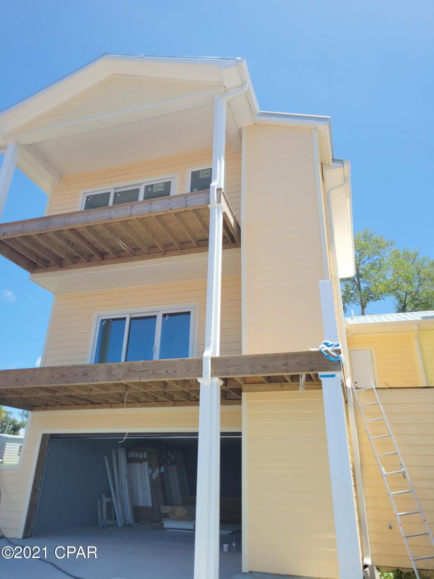 New construction of fabulous waterfront home. Premier construction from one of the oldest builders in our area. The perfect time to pick you choices of colors, floorings and fixtures. Nothing better then the chance to actually see quality of construction before sheet rock walls go in place. Now let's talk about views. WOW they are off the charts with sunset westerly views over the Bayou and the marina. The home boast three floors with large private balcony on main second floor and additional balcony on upper master level. The home is being prepared for granite counters through the kitchen and bathrooms . High end allowance for kitchen appliances as well as lighting and plumbing fixtures. Instant on demand heat to handle as  many family or guests your enjoying. Don't wait long.