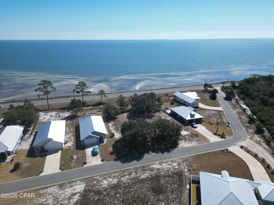 Build your coastal dream home on this 0.76-acre vacant lot in the gated community of St. George's Bluff, overlooking St. George Sound and Apalachicola Bay. Positioned high and dry in Flood Zone X, this homesite offers elevation, privacy, and the potential for stunning sunrise and sunset views across the water.

Surrounded by Tate's Hell State Forest, the community offers a rare combination of seclusion and convenience. Enjoy a private gated entrance, community pool with restrooms and changing stations, underground utilities, onsite boat and RV parking, and access to the private dock just steps away.

Located in the heart of Franklin County's Forgotten Coast, you're minutes from Eastpoint, historic Apalachicola, Carrabelle, and the white-sand beaches of St. George Island. This area is known for world-class fishing, boating, dining, and Old Florida charm.

Spacious, build-ready, and beautifully positioned, this is an exceptional opportunity to create your own retreat in one of the area's most desirable bluff communities.