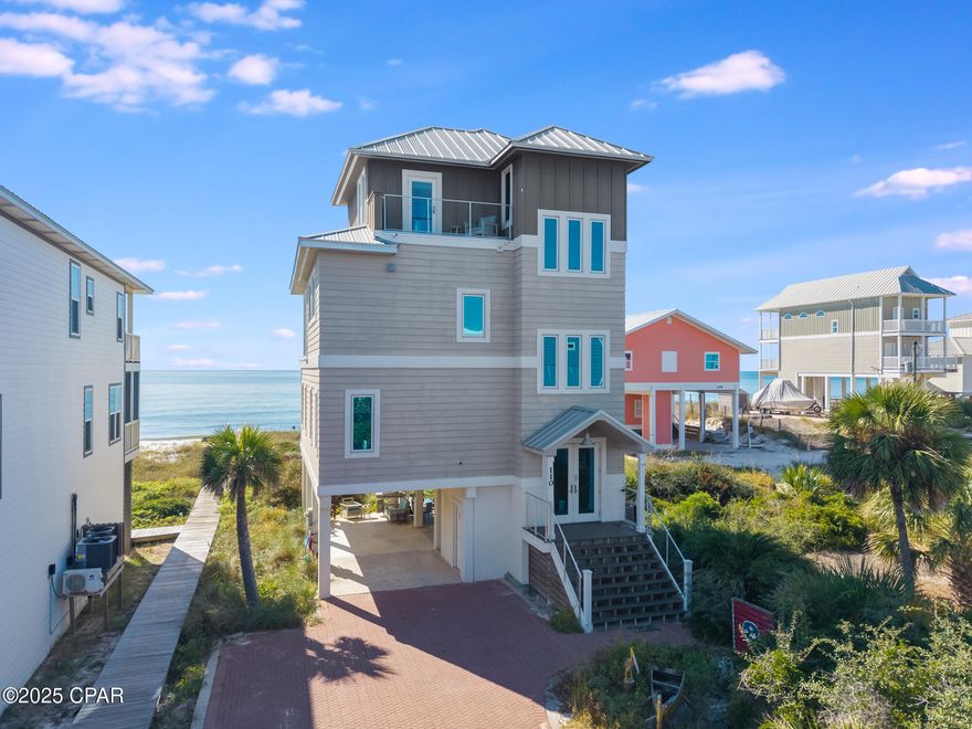 Located directly on the Gulf of America, Singing Waves (formerly Mar-A-Lago) is a beautifully updated beachfront home on North Cape San Blas offering panoramic Gulf views and a peaceful coastal lifestyle. This three-level retreat complete with newly refurbished elevator, combines timeless style with modern comfort, featuring wrap-around decks, private beach access, and a new outdoor fire pit perfect for evening gatherings by the sea. Inside, natural light fills an open-concept living area designed to maximize views. The gourmet kitchen includes custom cabinetry, premium appliances, a prep sink, and a stand-alone ice maker. Shiplap walls and ceilings, warm coastal finishes, and an inviting layout create the perfect setting for family gatherings or entertaining guests. The home offers four bedrooms and three and a half baths, comfortably accommodating up to twelve guests. The top-floor primary suite features vaulted ceilings, a spa-inspired bath with a soaking tub and walk-in shower, and a private upper deck showcasing the best views in the house. Additional features include an outdoor shower, fish cleaning station, gas grill, ample parking, washer/dryer, fast Wi-Fi, and central air conditioning. Beyond the property, Cape San Blas offers pristine natural beauty and endless outdoor recreation. Nearby St. Joseph Peninsula State Park is renowned for its white-sand beaches, kayaking, shelling, and nature trails. The Loggerhead Walk/Bike Trail winds through the Cape, while the St. Joseph Bay Aquatic Preserve invites exploration by kayak or paddleboard with opportunities to spot dolphins, sea turtles, and coastal wildlife. Perfect as a primary residence, vacation retreat, or investment property, Singing Waves embodies the best of Gulf-front living, where every day begins and ends with the sound of the waves and the glow of a Cape San Blas sunset. Some dimensions were taken from the Gulf Co. Property Appraiser's website, Survey on file.