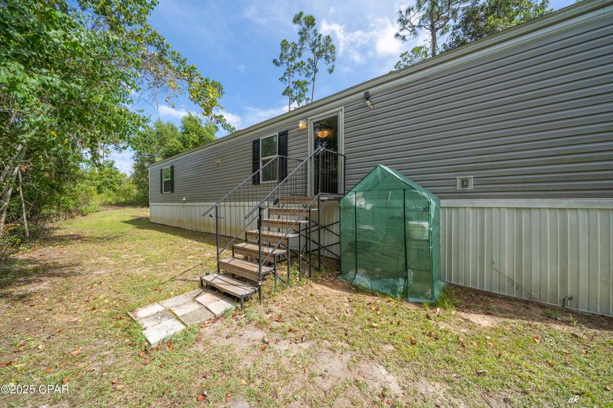 Welcome to this beautifully maintained, modern 2-bedroom, 2-bath single wide mobile home built in 2022 is perfectly situated at in the serene area of Fountain, FL. Positioned just 30 minutes north of Panama City, its convenient location also offers a quiet, country secluded feel while being easily accessible to all the area has to offer. 

Step inside to discover a clean and open floor plan featuring spacious living areas, a well-appointed kitchen with ample cabinet space, storage and sleek finishes throughout. The split floorpan offers sizable bedrooms with generous closet space and privacy, complemented by two full bathrooms designed for convenience and comfort.

Enjoy the peaceful surroundings and the ease of maintenance that comes with a newer home. Whether you're a first-time buyer, downsizing, or looking for a cozy getaway, this property offers the perfect blend of comfort, functionality, and modern living.

Don't miss your chance to own this move-in ready gem in a tranquil location—schedule your showing today!

-Located in flood zone A but have Elevation Certificate on file. 
-Boundary Survey on file.

*Please note, the drop in gate off of the back porch does not convey in the sale.

**Buyer to verify all measurements and information, if important.
