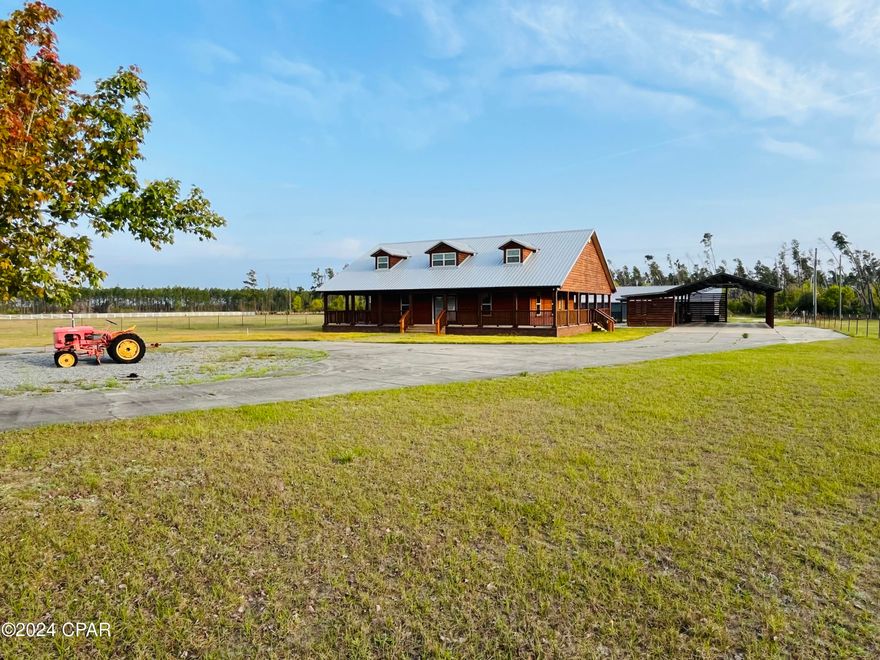 Nestled on an expansive 20.76+/- acre canvas of Northwest Florida beauty, this Ranchette style compound comes with a 	
2000 sq ft main residence, large barn and sheds, a beautiful entrance and paved driveway, along with numerous other amenities that make this one of the most turnkey family retreats in all of Liberty County. Given the central location, it is a quick 1-hour drive to Tallahassee and a 1.5-hour drive to Panama City beach.

The home itself boasts 3 bedrooms and 2 bathrooms. The master suite is complemented with a large walk-in closet, large bathroom and double vanity. The home is also wired with security systems and features a Rinnai water heater for fast hot water. The kitchen is equipped with stainless steel appliances, beautiful countertops, and oversized wood cabinets. Other features of the home include beautiful wooden floors, tall vaulted ceilings, and large laundry room with ample storage space.

Outside, you will find a spacious wrap around porch that serves as a great area to lounge around and enjoy time with friends and family. Large, covered carport, with outdoor kitchen next to the saltwater pool for your entertaining and enjoyment. Meanwhile, the expansive grounds make it ideal for horse boarding, training, or simply enjoying the tranquility of country living. The 6,500 sq ft pole barn with its spacious concrete floors make it ideal for a large shop, heavy equipment, RV, boats and so much more! 

If desired, the property is currently set with power and septic that could be parceled in such a way that one could sell off a tract with ease to either recoup some of their investment or deed a portion of the land to a family member.