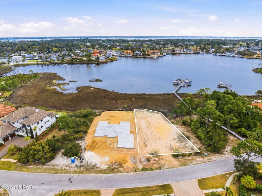 Rare opportunity to own a premium waterfront homesite in the highly sought-after gated community of Finisterre. This exceptional lot has been thoughtfully improved with fill dirt and a new seawall, providing a solid foundation and valuable cost savings for your future build.

Enjoy direct water access with two designated jet ski spaces at the community dock, conveying with the purchase and perfectly suited for embracing the coastal lifestyle. Whether you are planning a custom luxury residence or a private second home retreat, this property is ideally positioned to capture stunning views of Grand Lagoon and its natural beauty.

The seller also offers beautifully designed Mediterranean-style house plans, customized specifically for this lot, adding further value and convenience for your build.

Finisterre is a gated waterfront community featuring amenities such as tennis courts, pickleball, basketball, a playground, and a community dock. Ideally located just minutes from local marinas, some of Panama City Beach's best dining, and only a short golf cart ride to ''World's Most Beautiful Beach'', this property truly offers the best of both boating and beach living.

Opportunities like this in Finisterre are limited. Secure your slice of paradise and begin building your dream coastal home today. This listing contains photos with conceptual rendering for illustrative purposes only.