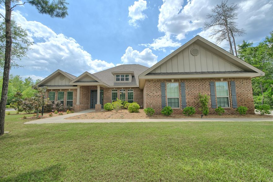 Spectacular 4 bedroom 3 bath brick home located on a corner lot in Lake Merial subdivision. This Home has quality features and accents such as dining room, home office, crown molding, trey ceilings in the dining room, family room & master suite, hardwood flooring & tile flooring, 10 & 12 ft. ceilings, amazing arched doorways and so much more. The gourmet kitchen boasts granite countertops, a huge island, stainless appliances, including cooktop, rangehood, wall oven and microwave/convection oven, pantry, painted cabinets with lighting, and is open to the breakfast nook. You will find the spacious master suite is truly a retreat, with large walk in closet, master shower which is beautifully tiled, double vanities and a garden tub. The master bedroom is large enough for a sitting area. There is an office at the front of the house with a peak of a water view of the lake. The three secondary bedrooms all come with large closets, bedrooms 3 and 4 share Jack and Jill bathroom with a double vanity sink. Bedroom 2 has a bathroom conveniently located across the hall. The exterior features a screened in patio, fenced backyard with double gate access to the extra long driveway and side entry garage. There is also a well for the irrigation system.

Lake Merial is a 300 acre gated lake front community with private owner access to the lake for swimming, kayaking, and fishing! The Community has 2 natural spring fed lakes, white sandy beaches, park areas for playing, picnicking, or relaxing.  There are 100+acres of walking trails. This neighborhood provides underground utilities, sidewalks, You will love the lifestyle the beautiful gated community of Lake Merial has to offer. Age, Square Footage, lot and room sizes approximate, if important please verify.