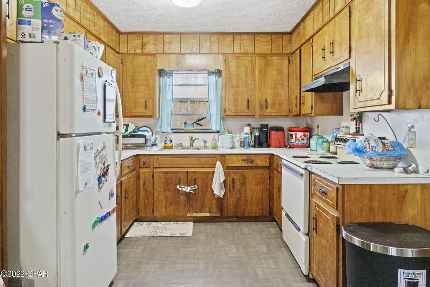 Three bedroom, one bathroom home with attached carport located on a paved road.  Kitchen has plenty of cabinets.  Living room is open to the dining area.  Primary bedroom has a walk in closet.