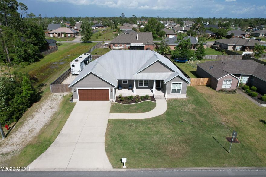 The search is over for a ''custom build'' with all the bells and whistles! Located on TWO lots in popular Lynn Haven, this 4 bedroom, 3 bath immaculate home has high end finishes and unreal curb appeal. The moment you enter the front door you will want to soak it all in! The floors are beautiful tile, the ceilings are smooth, and the lighting and extra details will have you breathless. The ''over the top'' kitchen with a gas cooktop and double oven will make you look for a reason to cook! Enjoy the abundance of hot water with your Rinnai tankless water heater and lower power bills with blown in insulation. The farm sink in the kitchen and double vanities in the master are on wish lists everywhere- Pocket doors are located in instrumental places, surround sound is there to to enjoy, and the screened-in back porch is definitely an added feature with a view of the large fenced in yard ! Words cannot describe this home adequately, so don't pass up the chance to be the proud new owner. There is a decked attic for extra storage and the sellers added new gutters and a top-of-the line back flow preventer for code compliance.  A 50 amp connection for an RV was also installed. The concrete driveway easily holds four vehicles in addition to the spaces in the double garage. A gravel drive is also next to the garage with a double gate for boat or RV storage- No HOA fee, it is truly "the one" to SEE!