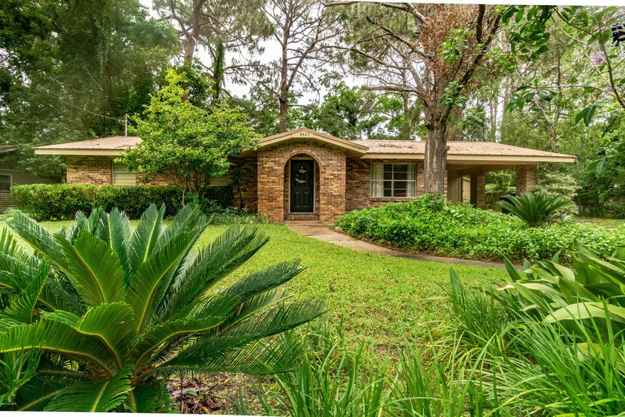 This spacious 3/2 brick home is located on a large lot close to Tyndall AFB and shopping. This home features a metal roof, new laminate wood flooring in family room, new vanity and light fixture in master bathroom, new hardware and light fixtures throughout home, new interior doors, wood burning fireplace, spacious laundry room with new cabinetry and plenty of space for a freezer, large backyard with 14x24 workshop with electricity and a covered patio area.  All info/sizes/measurements approx, please verify if important.