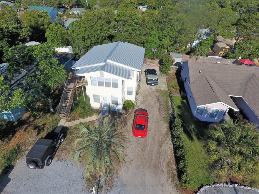 Excellent investment opportunity in Panama City Beach with strong rental income.  Attractive duplex in super location only three blocks from the beach!  Very convenient…only 3 miles from all the great shops and restaurants at Pier Park, yet tucked away on a quiet street among nice homes.  One unit is upstairs and one is downstairs, and both have one bedroom and one bath with a sunroom and back deck overlooking private backyard. Plenty of light inside and the building has the charm of hardwood floors and metal roof with vinyl siding for easy maintenance.  Many upgrades including newer paint, air conditioners, appliances, blinds, roof, etc. Shared washer/dryer in laundry shed.   Please do not disturb tenants.