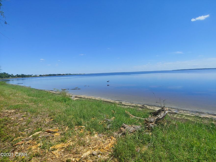 CURRENTLY UNDER CONTRACT, SELLER ACCEPTING BACKUP OFFERS. Waterfront Acreage! Beautiful property with mature oaks and over 200' of beach frontage on East Bay! Don't delay in seeing this fantastic investment soon. Currently zoned for Mixed Use, many possibilities available for development including Low and Medium Density residential uses such as single family, apartments, townhomes, condominiums, as well as RV Parks and Subdivisions! Walk right out on the sandy beach of East Bay, with Under the Oaks Park, and Earl Gilbert Park and Boat Ramp within Blocks! This area is growing fast, and only a couple miles to Tyndall Air Force Base. All dimensions and uses approximate, buyer to verify.