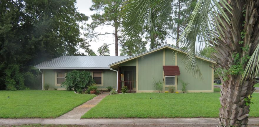 Beautiful 3/2 home great for a family! The spacious living area has a vaulted ceiling & includes the enclosed garage.  It can be one great room or separated into a separate office or living room.  With the fireplace & big screen TV, (included w/purchase!), you will be proud to have your friends over.  There are many nice touches you'll love about this home including fresh paint in calming colors, a pleasant backsplash in the kitchen, nice landscaping, and plenty of parking between the carport and extra driveway.  The metal roof keeps the insurance low and the big backyard is great for the kids & pets.  The home did have damage from Hurricane Michael but should be put back to normal in time for a January or February closing.