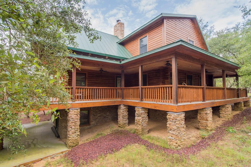 LUXURIOUS CUSTOM BUILT LOG HOME � This is an absolutely stunning 3 bedroom, 2.5 bath, 3950 square feet, one of a kind home situated on 10 acres and a pond.  The natural beauty of the locally cut cypress used to construct this home is just one of many factors that make this a truly spectacular find. Beautifully finished hardwood pine floors can be found throughout the first and second floors. The basement level includes a bonus family room and a second fireplace with an authentic millstone inlaid into the stacked stone fireplace. The first floor features a beautiful kitchen with center island, Corian counter tops, soft close cabinet doors and drawers and stainless steel LG appliances.  The spacious great room has a beautiful stone fireplace, open beam ceilings and large windows which provide wonderful views of the property.  There are 10' ceilings throughout and every room in the home is accented with custom trim, custom solid wood doors and 8 inch baseboards.  The interior columns in the home are beautifully finished whole cypress tree trunks and the railings on the 2nd floor balcony are made from sparkle berry vines. The master bath includes a whirlpool tub, tiled separate shower, private water closet, his and her vanities and a heated tile floor.  All of the bedrooms are over sized and one of the second floor bedrooms has an adjacent private office.  Two of the rooms on the basement level are heated and cooled but unfinished.  The floors are concrete, the walls are block and one of the rooms is plumbed for a 3rd full bathroom.  Both rooms are very large and can be completed for use as additional bedrooms, game room, movie theater or man cave.  The entire home is surrounded by a covered wrap around porch.  The property includes 2 barns and 2 pole barns.  It also includes a fisherman's cabin complete with bunk beds and a screened porch.   There are two docks on a beautiful natural pond and a small bridge leading to other areas of the property. For the buyer looking for more space, the sellers have made 140 additional acres of adjoining land available.  This additional property is offered at $350,000.  Most of the combined 150 acres of property is in its natural state and is an ideal place to ride horses, hunt, fish or simply enjoy the natural setting.    Please call to schedule your private tour of this unique home.