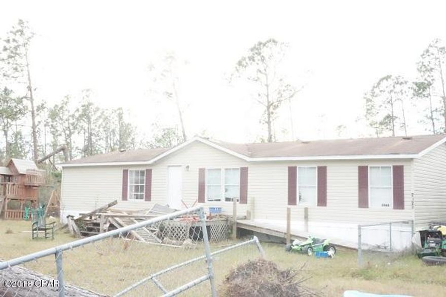 Make this one your own.  Repair current home, build your dream home or put a new mobile home on this 2+ acres close to town. Front part of acreage is fenced for the kids and pets and has a 24 x 20 pole barn for parking or storing larger toys.  It also has a 16 X 24 workshop with electric  for the handyman.  On the back part of lot is a pond which needs to be dredged  deeper to keep water from spilling over into the yard.  Back part of lot is in a flood zone but house is not so no flood insurance needed.  Value is in the land and buildings but what a buy this close to town.