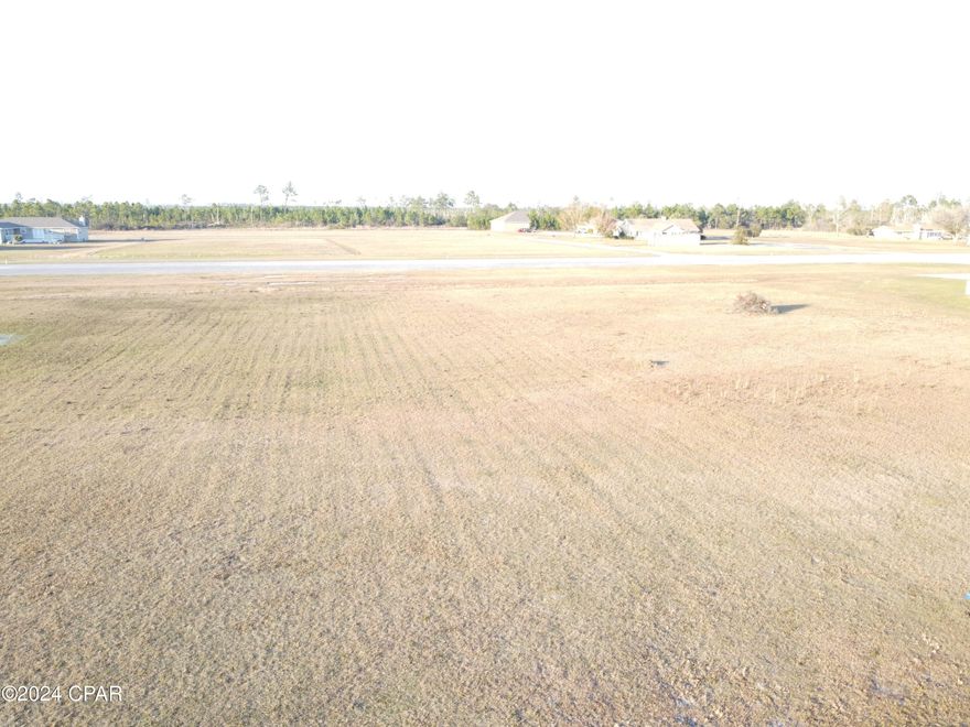 This lot is on the runway! One of the rare lots in Flood zone X. Welcome to Sandy Creek Air Park, a gated pilot's paradise. Experience the freedom of flying far from the restrictive airspace of the big city. This gated community offers underground utilities and a community center. This lot features taxiway access to the runway.  The paved runway is 3200 feet with lights and a beacon for nighttime flying. The FAA airport designator is 75FL located on the New Orleans sectional chart.