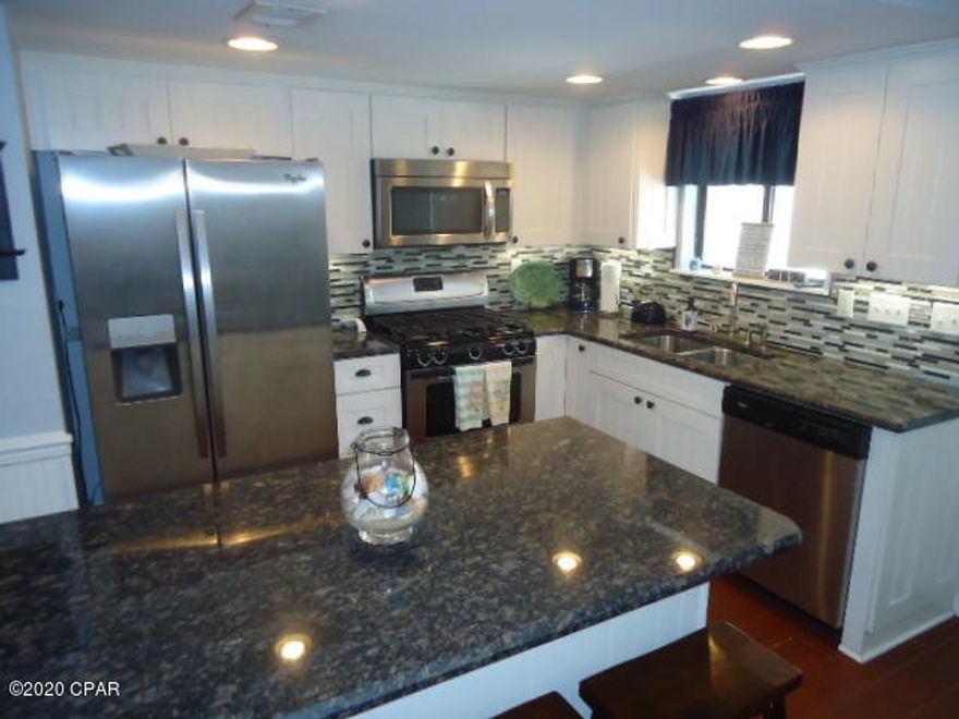 Currently under contract, sellers accepting back up offers. Age, SF, and dimensions approximate. Beautiful refurbished unit downstairs. Kitchen has granite counter tops and stainless steel appliances. Very close to beach walk. Complex has 11 pools to include clubhouse with a pool on the beach. Gated community and pet friendly. Great family vacation place for you second home or investment property.