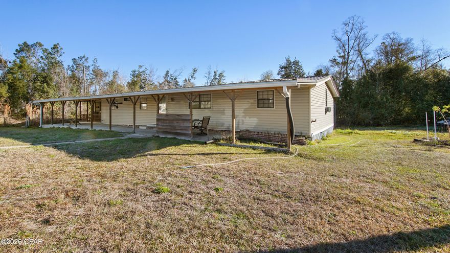 Spacious 4 bedroom, 3 bath home with an open floor plan sitting on a huge corner lot just over 3/4 of an acre. Located only about 20 minutes from Panama City Beach, you get the perfect mix of space and convenience.

Enjoy a fully covered front porch, privacy trees lining the front of the property, and a partially fenced yard with plenty of room to spread out. Out back you'll find a 20x20 shed for storage, hobbies, or workspace.

Major updates already handled with a new roof in 2019 and both the septic pump and well pump replaced in 2018. All appliances convey, making this one move-in ready.

One of the standout features is a bedroom with its own private entrance, perfect for a mother-in-law suite, guests, or even potential rental use.

If you've been looking for space, flexibility, and a great location close to the beach, this one checks all the boxes.