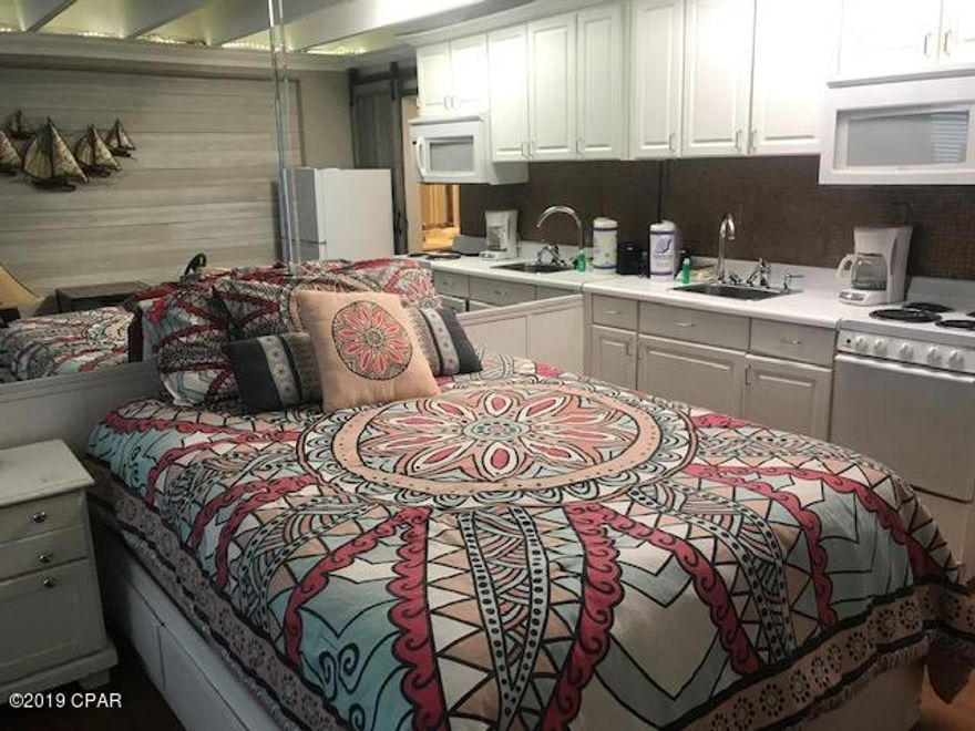 BEAUTIFUL REMODELED WATERFRONT UNIT.  IF YOU ARE LOOKING FOR A UNIT ON THE BEACH WITH LITTLE OVERHEAD, AND ALL UTILITIES PAID INCLUDING ELECTRICITY, WATER, AND GAS, THIS UNIT IS FOR YOU.  WATCH THE BEAUTIFUL SUNSETS FROM INSIDE YOUR UNIT AND JUST STEPS FROM THE SANDY WHITE BEACHES.  THIS UNIT IS TASTEFULLY DECORATED.  ONE OF THE BEST UNITS IN THE BUILDING.  LOW FLOOR AND CONVENIENT FOR LOADING AND UNLOADING.  THE COMPLEX IS UNIQUE AND WAS THE FIRST MID-RISE BUILT IN PANAMA CITY BEACH, WHICH IS ALSO ON THE NATIONAL HISTORICAL REGISTRY.  ENJOY THE MINIATURE GOLF, AND GO CART  TRACK  JUST ACROSS THE STREET.  YOU CAN ACTUALLY WALK TO RUNAWAY ISLAND RESTAURANT WHICH IS ONE OF THE PREMIER RESTAURANTS IN PANAMA CITY BEACH.  BEFORE YOU BUY ANYTHING ELSE, THIS IS A MUST SEE!  THE PRICE IS RIGHT!