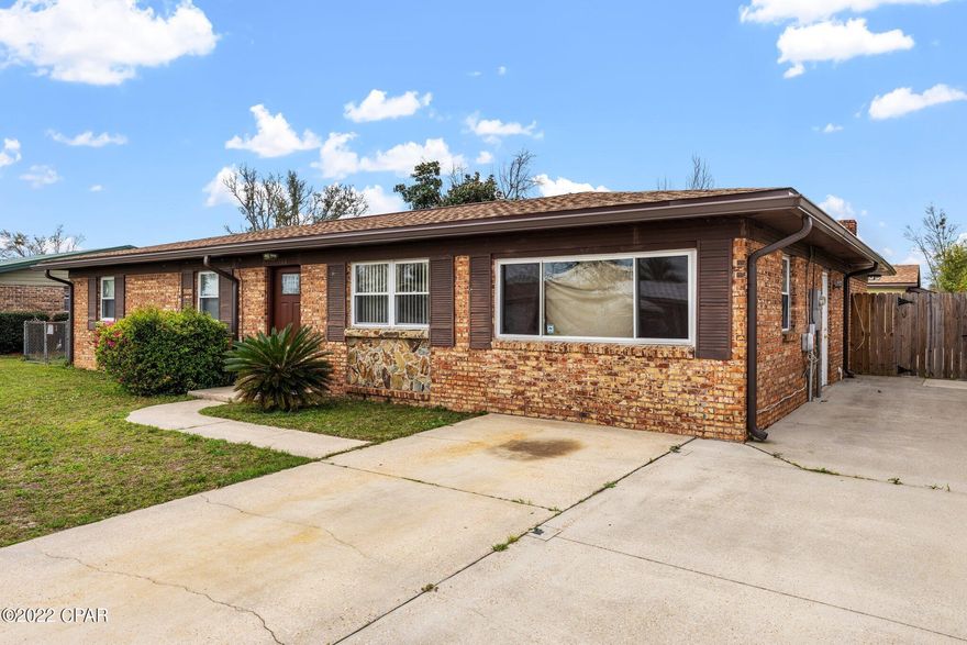 CURRENTLY UNDER CONTRACT, SELLER ACCEPTING BACKUP OFFERS Need a spacious house with multiple living areas? Want a pool? Want a detached garage with power and a garage door that would  also make a great pool house or workshop? Well, here is your house! Conveniently located to Tyndall Air Force base, this brick house offers three bedrooms, a living room, a den or private office space in the converted garage as well as a huge family room on the back of the house with a wood-burning fireplace & stone hearth. There is a dining area as well as a breakfast area off of the kitchen. The fenced back yard features a large in-ground pool. There is a covered parking area that would be great for a little boat and there is also a small shed attached to the workshop. The HVAC, roof , pool pump and garage door on the workshop are new. Call your Realtor today!