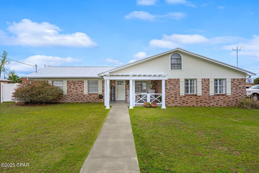 A Lynn Haven Gem on a Rare Double Lot - Where Comfort Meets Convenience!

Welcome home to the heart of Lynn Haven living, just two blocks from the vibrant Sharon Sheffield Park and minutes from local shops, dining, and community events—all just a golf cart ride away!

This beautifully remodeled 3-bedroom, 2-bath residence sits on an expansive double lot and is brimming with character, charm, and thoughtful updates. From the moment you arrive, the curb appeal enchants with dual driveways—including a circular front drive and double-wide parking pad—and a spacious, welcoming front porch perfect for evening unwinding.

Inside, you'll find space for everyone and everything. Two distinct living areas give you the flexibility to entertain in a formal setting with a custom accent ceiling or cozy up in a relaxed lounge featuring a wood-burning fireplace. Need a home office or hobby room? A bonus room tucked just off the living space adds even more function.

The primary suite is a true retreat—complete with an oversized sitting area, large walk-in closet, luxurious en suite bath, and private access to your back patio and sparkling in-ground pool.

The kitchen is the heart of the home, equipped with a center island, stainless steel appliances, and gorgeous cabinetry designed for the most organized of chefs—think lazy Susans and pull-out metal organizers that make every inch count.

Step outside to your private backyard oasis: a newly resurfaced pool ready for summer fun, an entertainer's patio, a secure privacy fence, a parking pad perfect for your RV or boat, and a large shed for your tools and toys.

Don't miss your chance to call this exceptional property home—schedule your private tour today! (Furnishings negotiable)