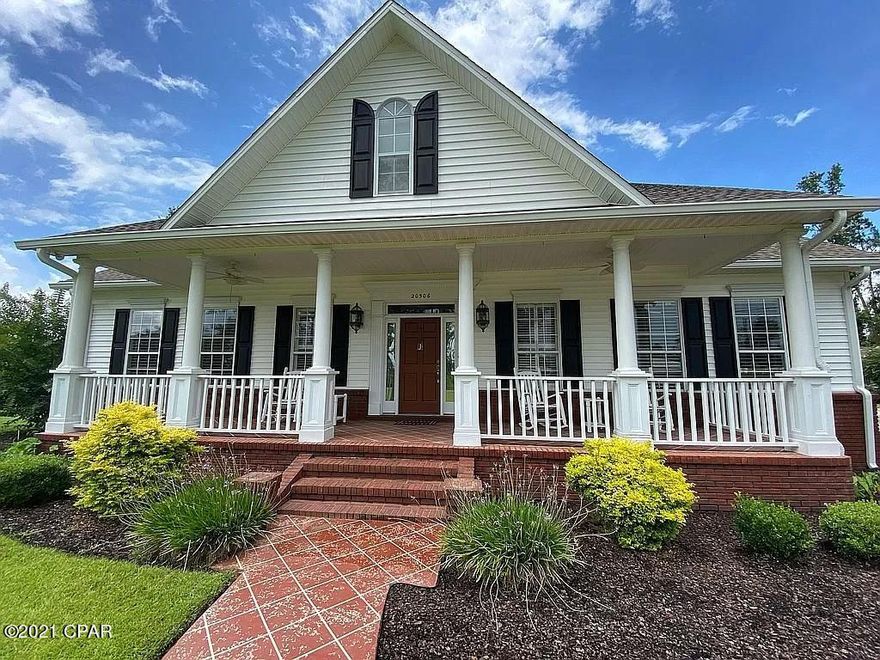 A TRULY WONDERFUL HOME!!! Featured in Southern Living Magazine after its build/completion. Some of the great things you will notice - two hundred and ten feet of road frontage, a grand front porch that expands the southern elegance of this home from the inside to the outside—the perfect atmosphere for winding down from a long day or relaxing throughout your weekend. Upon entering the house, you will feel the living room's cozy fireplace that greets you and warms your senses by making you feel right at home. The gourmet kitchen features a large center island for extra workspace for those creative dishes and holiday baking occasions. Granite counter-tops, LOTS of counter space, and custom cabinetry. Another large porch off of the kitchen for entertaining guests. Three bedrooms, two baths in the main home with 1780 heated and cooled sq. ft., and over 3000 sq ft under roof, including the porches and the oversized portico that can accommodate up to a 26ft boat and vehicle. 
The living room, the additional bedrooms, and the hallway feature beautiful engineered hardwood floorstile throughout the kitchen and bathroom areas. In addition, the Master-Suite has luxurious carpets. 
The detached guest home is one bedroom and one bathroom with a living room and a fully equipped kitchenentirely independent utilities from the main house. 
A unique home with too many great features to list. The main components are new, including a recent roof installed in 2019, new gutters, new kitchen appliances. The irrigation system operates on a separate well system. If having privacy and the tranquility of country living this one is for you. Only an hour's drive from Panama City Beach and Tyndall Airforce Base.