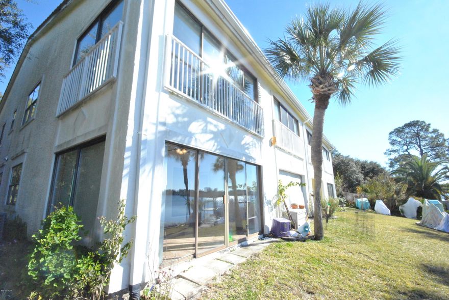 Come discover the beautiful views of North Lagoon with this wonderful waterfront condo.  This condo features new carpet, new paint,  new flooring in the kitchen, new AC, new roof, fantastic Florida Room overlooking North Lagoon, and much more.  Outside of course you have a great water front view with community pier and boat dock.  Visit the East end of Panama City Beach and see what you have been missing, quiet, centerally located to Navay Base, Schools, shopping and less than a mile to the worlds most beautiful beach!  Call today for additioanl detail.