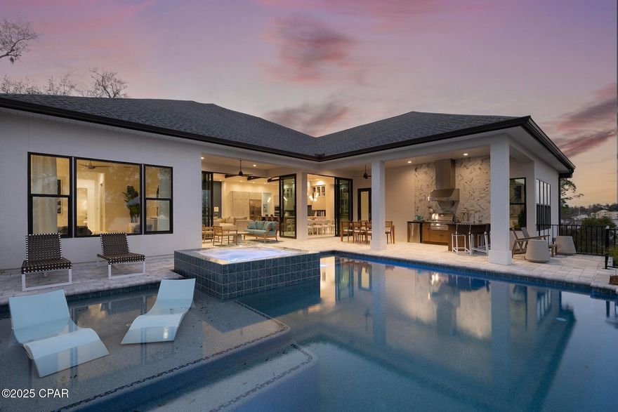 Waterfront Luxury - Fully Furnished Arthur Rutenberg Home - where elegance meets effortless living. This fully furnished, professionally decorated AR Homes by Arthur Rutenberg Home offers over 5,000 total square feet under roof and is ready for immediate move-in. Situated on 154 feet of deep-water bayou frontage, this 4-bedroom plus den residence showcases soaring vaulted ceilings, exposed beams, and designer finishes throughout. The home includes a Home Delivery Center for secure, contact-free package drop-off, and features expansive disappearing glass walls that open to a resort-style outdoor living area with a vanishing-edge pool, outdoor kitchen, lanai, and cabana. Located in the upscale community of Cove Pointe, with low HOA dues, this exceptional property offers direct access to Shell Island and the Gulf of America. Offered fully furnished, this is a rare opportunity to own a turnkey luxury waterfront home designed for both everyday comfort and high-end entertaining.