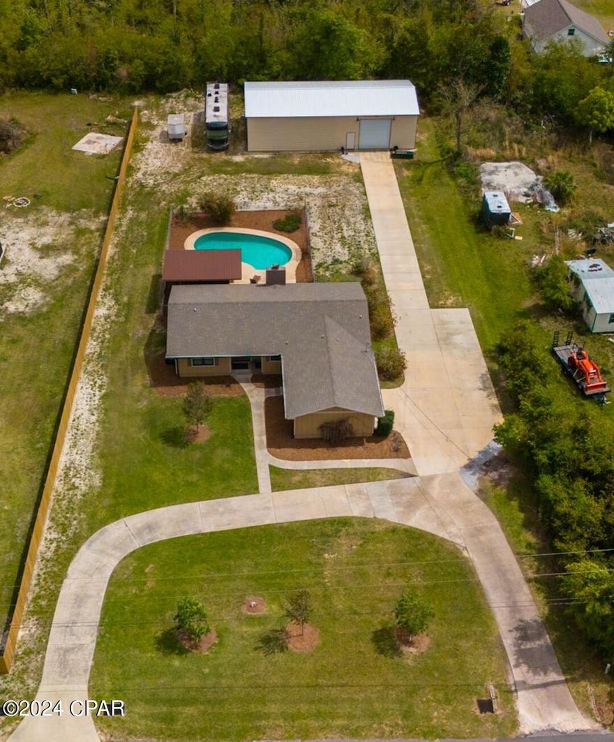 Welcome to this charming, fully renovated Ranch-style home nestled on nearly an acre of land adorned with mature trees, offering both tranquility and privacy. Located in the heart of Lynn Haven, this property provides a serene retreat from the hustle and bustle of city life.

As you approach the home, you'll be greeted by the classic appeal of the Ranch-style architecture, featuring a low-pitched roofline and a sprawling single-story layout. The exterior has been updated with fresh paint and modern finishes, enhancing its curb appeal while maintaining its timeless charm. with a spacious front yard and circular Driveway

Stepping inside, you'll find yourself in a thoughtfully redesigned interior that seamlessly blends contemporary comforts with the home's original character. The open-concept living space is bathed in natural light streaming through large windows, creating a bright and inviting atmosphere.

The renovated kitchen boasts sleek countertops, stainless steel appliances, and ample cabinet space, making it a chef's delight. Whether you're preparing a casual breakfast or hosting a dinner party, this kitchen is sure to impress.

The spacious master suite offers a peaceful retreat, complete with a luxurious ensuite bathroom featuring modern fixtures and finishes. Two additional bedrooms and a beautifully updated guest bathroom provide comfort and convenience for family and guests alike.

Beyond the main house, the property features an in ground pool with Gazebo and fencing. beyond the fenced yard is a  sprawling 30x65 workshop, providing ample space for hobbies, storage, or a home business. With its own entrance and utilities, this versatile space offers endless possibilities for customization to suit your needs.

Outside, the expansive yard offers plenty of room for outdoor activities and relaxation. It also has plenty of parking for your boat and your Motor home. Call me today to see this beauty.