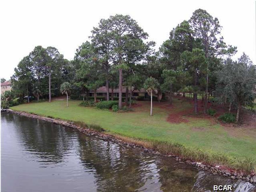 STUNNING WATERFRONT VIEWS FROM THIS HOME ON PRETTY BAYOU, LOCATED ON 1.5 ACRES! This home has been a one owner home since it was built 52 years ago. As you drive in the driveway, the gorgeous oak trees will take your breath away. Spacious foyer is accessed thru large double front doors. The formal living room and dining room have plenty of room for hutch, buffet and large dining table. The Den has expansive views of the Bayou, beautiful cypress paneling that goes into the breakfast room, which also has a large sliding door to back porch. The kit has a ton of cabinets, a wet bar area, a desk area and plenty of room for a island, if desired. You won't mind doing the dishes with the view from the kit sink! 300' of water front, from which to watch the dolphins and birds! The Bayou