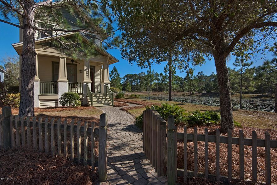 GORGEOUS Coastal Craftsman bungalow privately situated on a small lake in the beautiful gated neighborhood of Wild Heron. This is a favorite floor plan of the community because of the screened side patio.  Plus its location to the lake and all the amenities that Wild Heron is famous for make it all the more desirable.  The home is located on one of the premium lots and is not on the main road affording more privacy and space.  The home is filled with light and includes a large kitchen, downstairs bedroom and full bath, dining nook looking over the lake, and large ample bedrooms and baths upstairs.  Wild Heron amenities include 24 hour guarded gate, swimming pool, boat house complete with kayaks and canoes, state-of-the-art fitness center, walking trails, and the sweetest neighbors ever. This bungalow has an ATTACHED garage for your convenience.