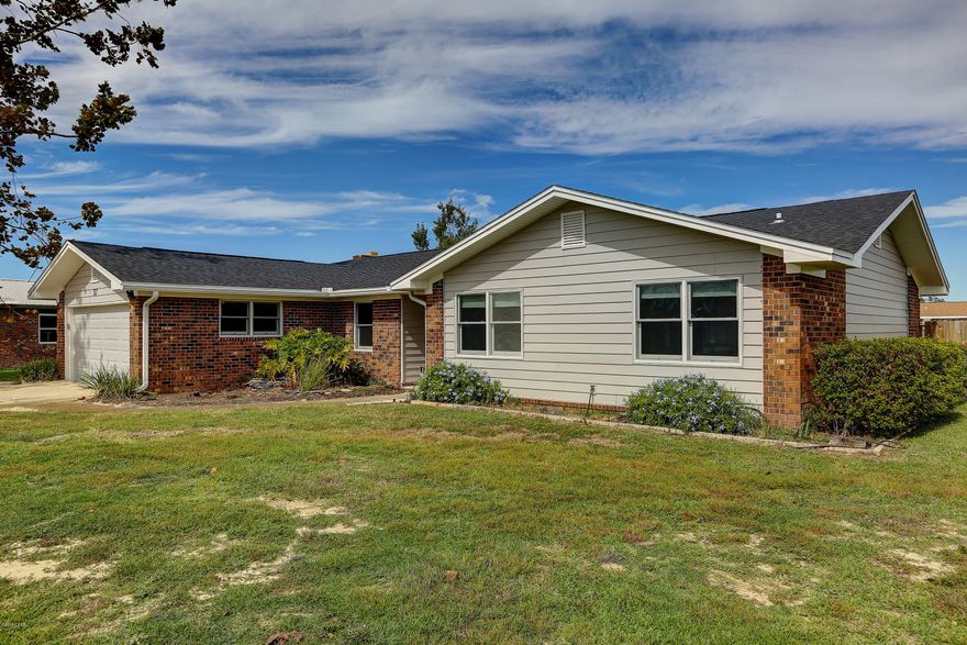 Spacious 4 bedroom 2 bath 2,225 sf Lynn Haven home in Belaire Estates.  This home has a new roof and new air conditioning system.  Highlights include large Florida room, wood burning fireplace in living room, granite counter tops in the eat in kitchen, formal dining room, built in cabinets and renovated master and guest bathrooms to include custom sea life tile motif.  The flooring throughout is tile.  There is a two car garage and a backyard shed for additional storage.  A working irrigation well is a plus.  The backyard is great for gardening and includes orange and grapefruit trees.  There is a Termite bond in place with Terminix.  Seller is currently having the fence replaced.   Make plans to see this one today!