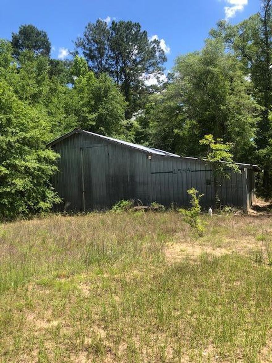 If fishing is your thing, you won't want to miss this opportunity to be this close to the Choctawhatchee River.  This property is located near the Wildlife Management Area & is only 1/2 mile from the Bear Hewitt Boat Landing.  Part of the property has been cleared, and there is a large metal barn with a concrete foundation.  Please note that there is an old manufactured home on the property that is in very poor condition.  It is not considered to be in livable condition, and is considered to be of no value.