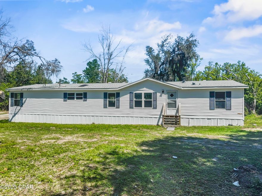 You'll instantly fall in love with this spacious 4 bedroom/2 bathroom manufactured home! With 1,890 square feet of living space on an oversized lot with a private pond, this property is a fishermen's dream! There is a 40 ft. dock that could use a little work, but the pond is stocked with bass! The kitchen is spacious and has an island and a new stove. It has a bonus room off of the master suite and the bathroom features a double vanity, garden tub, and separate shower.  The roof was replaced in 2018.  The AC was recently replaced, and the Seller just replaced all the carpet and painted ceilings and walls. The family room also features a wood burning fireplace. The home sits on three lots making it a little over an acre and is located on the end of a paved road.  There is a shed with a concrete driveway. Located just minutes from the heart of Panama City, this home is situated in a family-friendly neighborhood and offers easy access to local schools, shopping, dining, and entertainment. Plus, with nearby state parks and beaches, outdoor activities are never far away. This property offers ample space for those looking for room to grow, inside and out. Don't miss out on the opportunity to make this your family home. Schedule your showing today!