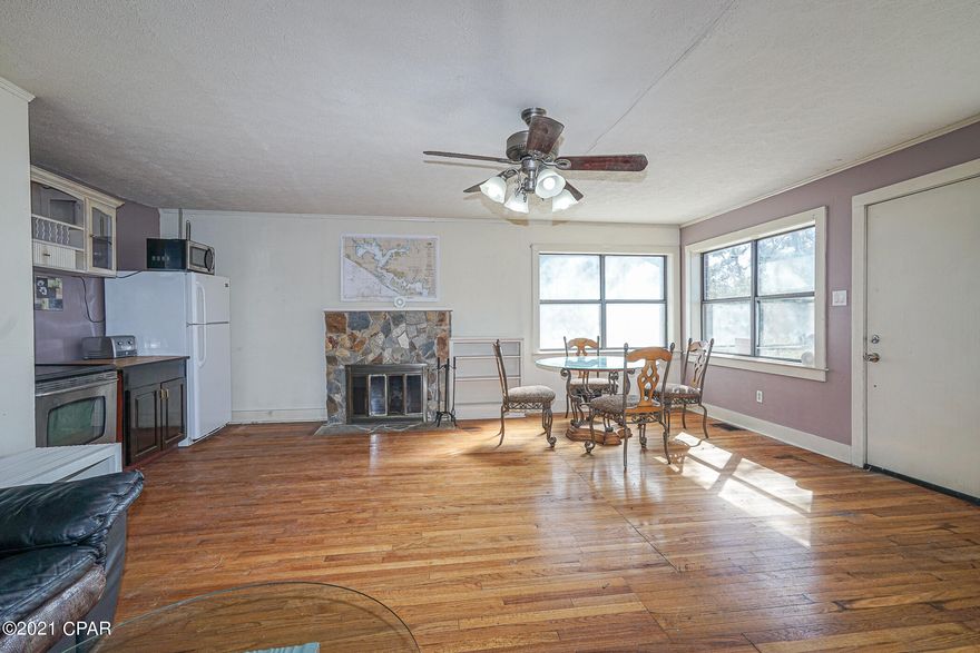 All-brick sprawling ranch home with tons of possibilities. OWNER-FINANCING AVAILABLE. Located on a massive 2.3+acre lot on a dead-end street with gorgeous mature trees and a picturesque creek, this 2,192 sqft single-family home is delightfully split into two units, each featuring hardwood floors, separate entrances, and kitchens. Sharing one water meter and power meter, it is ideal for multi-generational families or investors. As a bonus, the property has a second septic tank (re-certified by state of FL) which accommodates (with permit) detached two bedroom structure of your choice. Convenient for campers and adventurers, the large concrete pad was previously used for an RV and has power and water hookups. Other features: two-space carport w/potential for garage conversion, laundry room, basement, two large sheds, deck, wood burning fireplace, close to downtown Panama City, shopping, restaurants, and schools, owner-financing available, and much more! Property is in mixed use-two zoning, with endless possibilities for allowable uses, including storage building, bed and breakfast, attached dwellings up to four units, neighborhood scale commercial uses, retail business etc. From seasoned investors to savvy homeowners, this property delivers a wealth of potential. With tons to offer and perfectly situated on a dead-end street, this home will not last long. Call now for your private and exclusive showing!