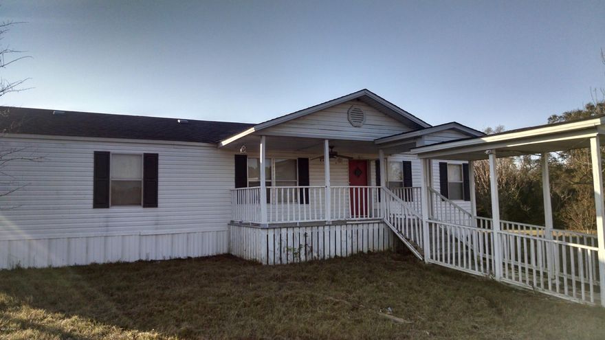 Great Deal on nice double wide located on 6 acres. Most of property is high and dry, on a hill. House is in good condition, needs a little work. There is an addition all the way across back of house that is unfinished. Has a storage shed and a small barn, with plenty of room for horses.