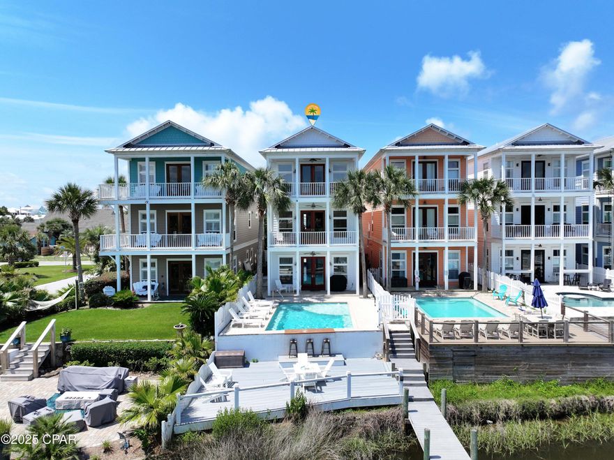 ***ABSOLUTELY STUNNING**** This AMAZING 4 bedroom 4 bath WATER FRONT home is located on the GRAND LAGOON which provides for easy access to the Gulf. The CUSTOM HOME boasts over 3500 sq. ft of LUXURY LIVING space, has a HYDRAULIC ELEVATOR that services all floors, 10 ft ceilings, 8ft doors, custom cabinetry throughout, oversized garage, is being SOLD FULLY FURNISHED and rental ready. The GOURMET KITCHEN has a LARGE ISLAND with ample seating, granite counter tops, under cabinet lighting, stainless steel appliances, a Wolf 5 BURNER gas stove top with hood, separate oven, ice maker, trash compactor and wine cooler. The main living area is open, airy and bright, has recessed lighting, vinyl plank flooring, PRIVATE BALCONY with AMAZING LAGOON and POOL VIEWS. There is an additional living area on the main floor  which provides for easy pool access and is equipped with a wet bar and mini refrigerator. The enormous MASTER SUITE has vaulted ceilings, recessed lighting, sitting area, private balcony with views of the pool and Grand Lagoon!. The master bathroom has a spa like shower, jetted tub, double sink vanity, granite counter tops, a HUGE WALK-IN CLOSET with custom built-ins and a mirrored dressing area. The outdoor space offers a GORGEOUS IN-GROUND POOL with swim-up bar seating, a large deck with a poolside bar and a PRIVATE BOAT DOCK with a lift. In addition to being on the Grand Lagoon for the boat lovers, the home is located just a short walk or golf cart ride to beach access and the ''Worlds Most Beautiful Beaches'' The home is located on the quieter east end of PCB close to shopping, dining, entertainment, state park and the best PCB has to offer. ***SELLER FINANCING AVAILABLE*** 25% down payment, 6.5% interest, 30 year amortization with a 5yr balloon.