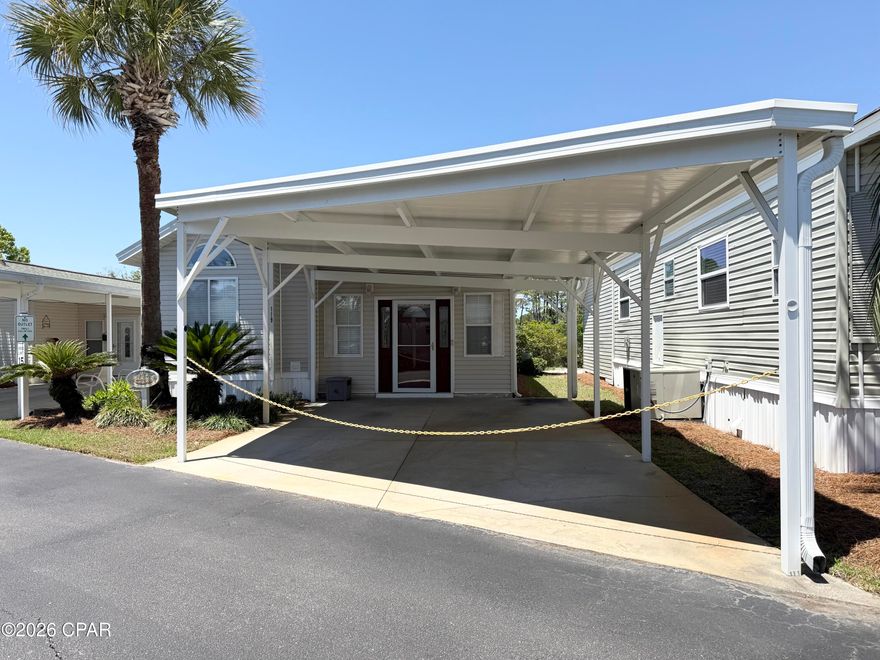 Well-maintained and impeccably cared for, this charming 2-bedroom, 2-bath home is located in the beautifully landscaped, gated community of Emerald Pointe Resort! Conveniently situated off Navy Blvd, this property offers easy access to Naval Support Activity Panama City, area golf courses, marinas, shopping, dining, and the white sandy beaches of Panama City Beach.  Enjoy resort-style living with outstanding community amenities, including a spacious clubhouse with a full kitchen, fitness center, two pools (one heated), hot tub, playground, shuffleboard, horseshoe pits, and a lakeside pavilion overlooking a catch-and-release fishing lake.  This move-in-ready home has seen numerous recent updates, including new engineered flooring, a new HVAC system, new water heater, newer roof, and a newer two-car carport. The enclosed rear sunroom with glass windows and a private door offers flexible bonus space. The utility room includes a washer and dryer along with a large 40-gallon water heater for added convenience.  HOA fees cover water, sewer, lawn care, sprinkler system, cable TV, trash pickup, and full access to the community amenities, making for easy, low-maintenance living. Whether you're looking for a primary residence, vacation getaway, or investment opportunity, this home is a must-see!