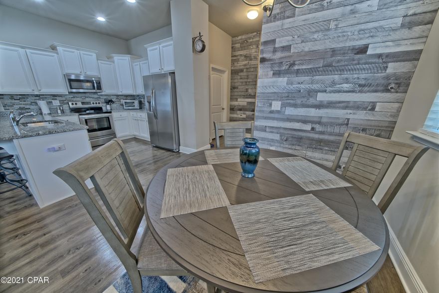 CURRENTLY UNDER CONTRACT, SELLER ACCEPTING BACKUP OFFERS**ABSOLUTELY GORGEOUS** This IMPECCABLY MAINTAINED 3 bedroom 2 and 1/2 bath townhome is BETTER than NEW with a FANTASTIC END CAP location, GARAGE & OVERSIZED PREMIUM LOT!.  This very LARGE OPEN  FLOOR PLAN offers almost 2100 SQ FT of upscale living!. The GOURMET KITCHEN has granite counter tops,  TILED BACKSPLASH, beautiful cabinetry, stainless steel appliances and a breakfast bar. The main living area has 10 ft CEILINGS, Luxury VINYL PLANK FLOORING, accent WOOD LAP SIDING and TONS of WINDOW!, The ELEGANT MASTER SUITE has a HUGE WALK-IN closet, The MASTER BATH has a double sink vanity with granite counter tops, large GARDEN TUB and a separate WALK-IN SHOWER!. WATERFALL is located close to the BEACH, Pier Park, restaurants and shopping