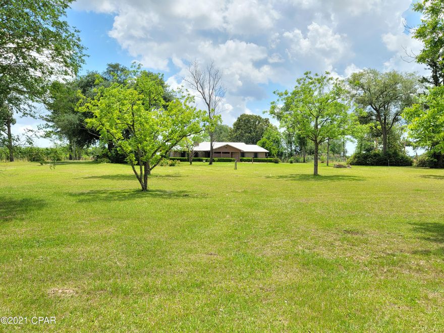 Amazing three bedroom, two bath brick home located on a beautiful 3-3.5 acres( to be determined with survey) in the country with a partially fenced yard. Home is in great shape. Nice front porch to sit on and enjoy watching the world go by. Wood burning or propane fireplace, metal roof. Home has awesome oversized heated and cooled sun room on the back, and a two car garage. There are 2 plum, 2, fig, 3 pear, 1 pomegranate and 4 pecans.  Home needs a little TLC but is priced accordingly.
