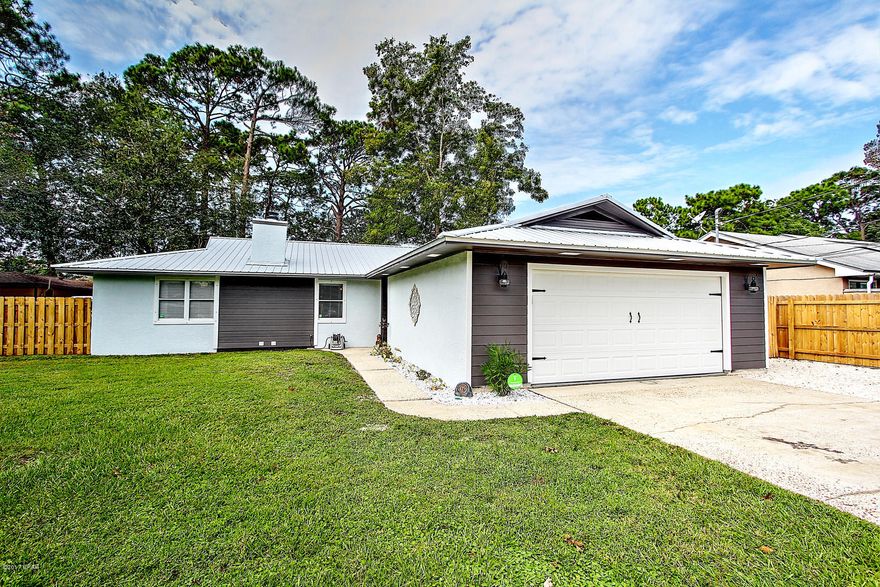 Beautifully updated Ranch in Grand Lagoon Shores. Minutes away from NSA Panama City. Close to the beach and Grand Lagoon, zoned for Breakfast Point Elementary. Tile in the living room, dining room, kitchen, hallway and bathrooms, carpet in the bedrooms. Refrigerator, stove, dishwasher, microwave, washer and dryer all convey. New roof in 2015, new appliances in 2016, upgraded vanity in 2nd bath and high efficiency toilets in 2015, upgraded hurricane garage door in 2015, freshly painted exterior in 2017, high end energy efficient washer and dryer. Security System, Large back yard with fire pit. Mirrored closet doors in the 2nd and 3rd bedroom. Upgraded faux wood blinds. On septic, city sewer access is avail per owner. All measurements are approx and should be verified if important to buyer.