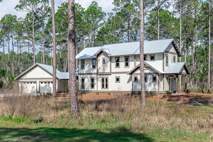 Upscale new construction retreat in the gated reserve of RiverCamps at Crooked Creek. Enjoy the modern rustic design in this 3 BR/3.5 BA home with 2-car garage. The first floor has 10' ceilings and includes a guest suite, powder room, and large kitchen overlooking an open concept living/dining area, plus a spacious screened in porch that is perfect for entertaining! The 2nd floor has 9' ceilings and includes a master suite, laundry room, loft space, and an additional bedroom. Notable features include 8' interior and exterior doors,  quartz countertops, oak shaker style cabinetry, designer light fixtures, Luxury vinyl plank flooring with carpet in bedrooms, Venetian marble countertops and subway tile in bathrooms. Exterior features include Navajo White Hardie plank lap siding with Timber Bark trim and a metal roof.  RiverCamps is a coastal sanctuary designed to embrace the outdoors that is bordered by water on 3sides, the Intracoastal Waterway, Crooked Creek and the spectacular 18,000-acre West Bay. RiverCamps community offers outstanding amenities such as a RiverHouse with swimming pool, and pavilion, a fitness center, trails and boardwalks, and a boat ramp with access to the Gulf of Mexico.