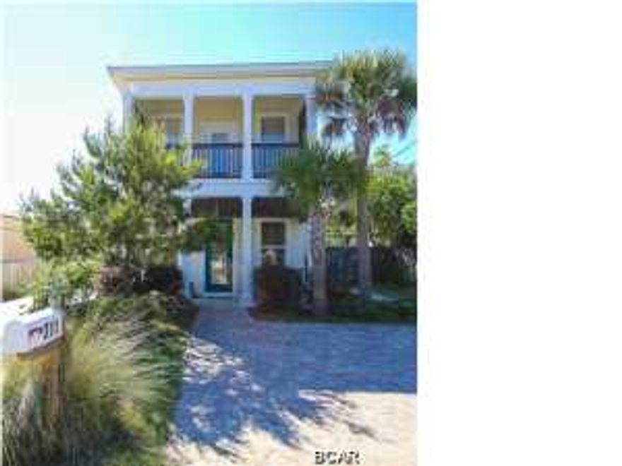 Sensational three story family home on Panama City Beach's west end with lovely gulf views, a large fenced in back yard and situated within an easy walk to the beach! Built in 2005, this spacious house boasts 3 large bedrooms plus one bonus room on the top floor that could easily be a 4th bedroom, (that is actually being used currently for that purpose). Three full bathrooms and one half bath throughout the home allow for ample privacy. When you walk through the front door you step into the roomy, airy living room, which in turns leads through to the dining area and kitchen. The kitchen is fantastic, featuring granite counters and stainless appliances, plus the ability to look out over to the living room as you prepare the meals - great for parents with small kids! Located behind