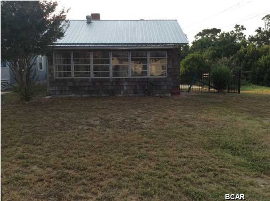 CHRISTMAS SPECIAL!!!!! If you are looking for a beach-get-away...This could be it... 1 Block...1/10th '' I'll repeat''...1/10th of a mile!!!... to dedicated Laguna Beach... You CAN see/ hear the Gulf from the road!... Great street in Laguna Beach!... WALK to Carousel or Thomas Doughnut's!!!!!... This IS a typical Laguna Beach OLD Florida Beach Home ...nothing more...''Who needs more?... You will be on the beach ALL DAY ANYWAY!... New flooring, New interior paint, new plumbing, 4 year old metal roof, 3 year old Hot water heater, AC checked out and working good and a Fireplace!... Over 1400 SF under roof including the 20 foot long enclosed Front Porch with windows!... Just imagine more sleeping area for the family on the porch:)..... Still needs attention on the outside but very liva