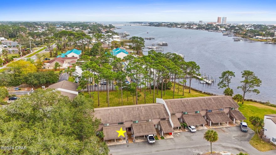 : MOTIVATED SELLER! 
Welcome to the Palisades! It is a peaceful waterfront complex with great views, a new dock, and a community pool. The green space off of the back patio is perfect for viewing the lagoon and enjoying time with family and friends. This condo has 4 bunk beds and a king size bed in the master.  Plus a queen size bed in the guest.  The sofa is a pull out sleeper. Beach access is less than a 10 minutes away.  Beautiful 2 br/2.5 bath condo with a carport/storage above it providing more space for storage. New LVP flooring upstairs in 2017, new HVAC in 2020, new washer & dryer in 2022 and new windows upstairs by the bunk beds in 2022. Furnished except for belongings in closets and cabinets. This is a must see so schedule your showing today!