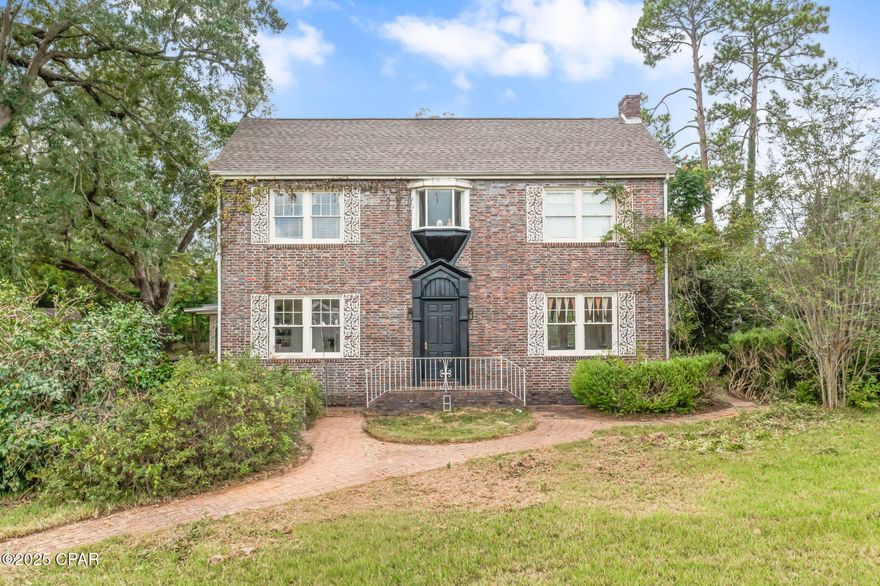 Timeless Brick Beauty on 1.8+/- Acres in the Heart of Marianna! Step back in time with this stately two-story brick home, nestled on a sprawling 1.8+/- acre lot shaded by mature trees. Bursting with character and charm, this 3 bedroom, 2.5 bath residence offers endless potential for those who appreciate vintage craftsmanship and classic architecture. Inside, you're welcomed by a grand foyer featuring original hardwood floors, a sweeping staircase, and beautiful arched doorways leading into spacious living areas filled with natural light. The living room features a cozy fireplace and large windows overlooking the serene grounds, while the formal dining room provides the perfect setting for gatherings. The home's timeless exterior showcases elegant brickwork accented with detailed trim, complemented by a concrete drive and covered carport. A 27x12 outbuilding with a full bathroom adds even more versatility—perfect for a guest suite, home office, or hobby space. The expansive lot provides plenty of space for gardening, outdoor entertaining, or future expansion. You'll enjoy the charm of small-town living while being just minutes from local shops, schools, and parks. With its grand presence and solid bones, this home is ready for its next chapter—bring your vision and make it your own!