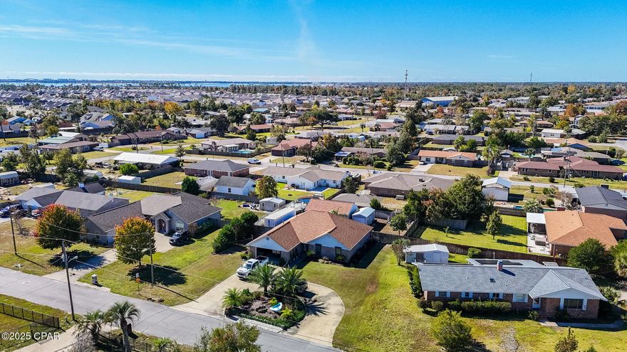 Welcome to this charming, meticulously cared for brick home in the peaceful Callaway Shores community, offering beautiful views of Callaway Bayou and over 1/3 acre of outdoor space. Enjoy the quiet, coastal lifestyle with a huge circular driveway and a 2-car garage.

Step inside to a bright living area with a vaulted ceiling and a comfortable layout. The master suite features cathedral ceilings, double doors, a private exit to the patio, a 5x5 walk-in closet, taller vanity, and a separate tiled shower with a bench and pull bars. Additional interior highlights include updated stainless appliances in kitchen and a built-in safe.

Stepping out on the back porch you will find yourself in true outdoor oasis, complete with a peaceful koi pond, separated from the rest of the yard with privacy fence. Throughout the property you will find raised garden beds, privacy fencing with double gates on both sides of the home, hurricane shutters, gutters, easy-care vinyl trim, and a separate well for the sprinkler system.

In addition to the impressive 20x30 insulated workshop with electricity, roll-up door, and window A/C, the property also includes a charming 10 x 20 insulated she-shed equipped with cabinets and extra storage, perfect for a home office, craft room, hobby space, or quiet retreat, wired with electric and window unit ac.

This home offers comfort, functionality, and an incredible location, don't miss your chance to make it your own!

Convenient to Tyndall Air Force base, shops, schools, restaurants and parks.