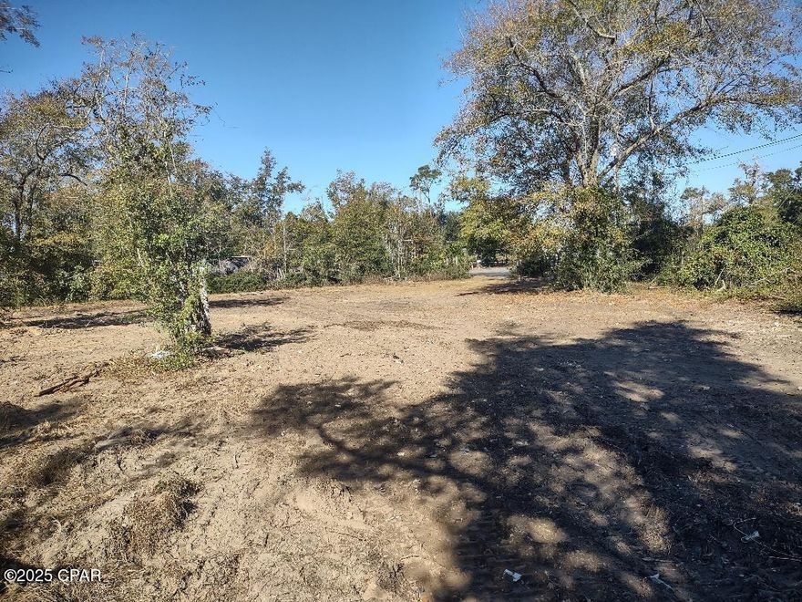 Pretty and large lot near Deer Point Lake in convenient area with all paved road access...Recently cleared and ready to build your custom home ~ or move a manufactured home onto site. Over half acre pie shaped lot with underground lines to power pole near back left of site, previous septic tank on site (near power pole), current water meter at road (near mailbox). Not many near ready to go sites like this in highly desirable subdivision area off Resota Beach Road on west side of Deer Point Lake. Seller selling AS IS - Buyer to have any inspections and confirm available usage of all utilities on site. Bay County is water utility source. Dimensions are from subdivision original plat (Plat Book 14 Page 118). Per tax records pie shape lot is .59 acre. Subdivision plat copy to attached to Documents tab.